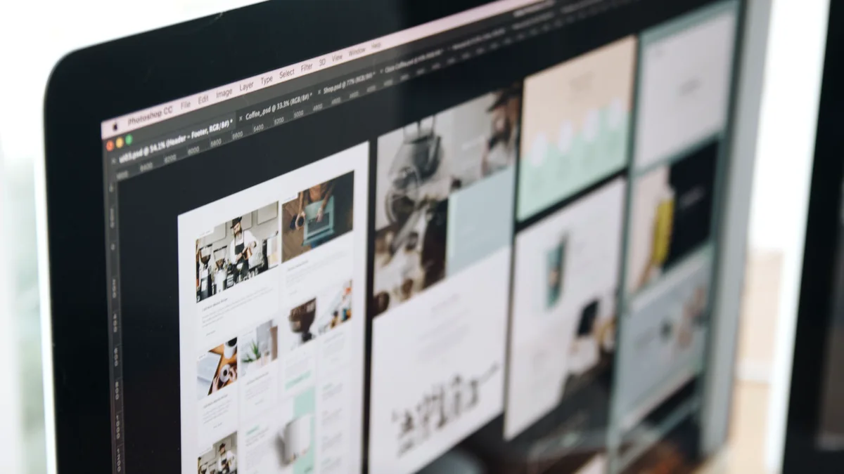 Computer screen displaying web design work in a studio