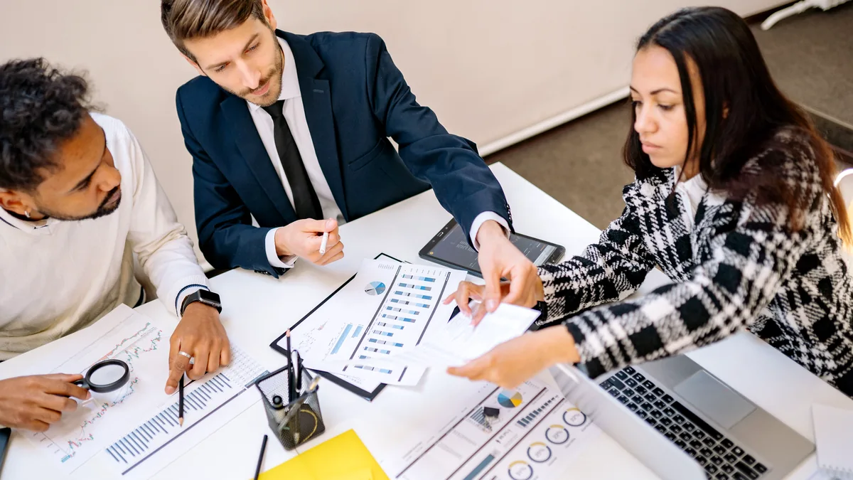 Business professionals collaborating over charts and documents